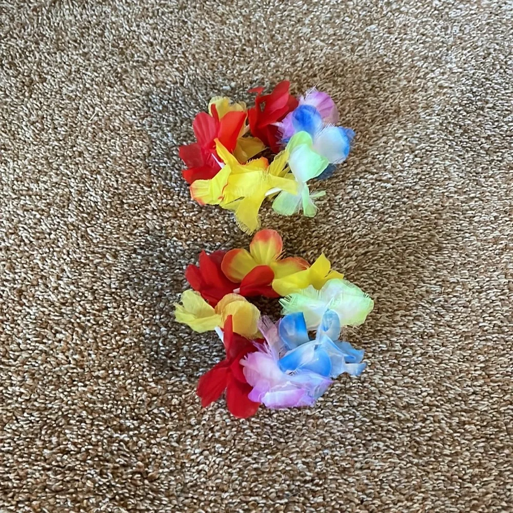 3 multicolored flower leis with two bracelets